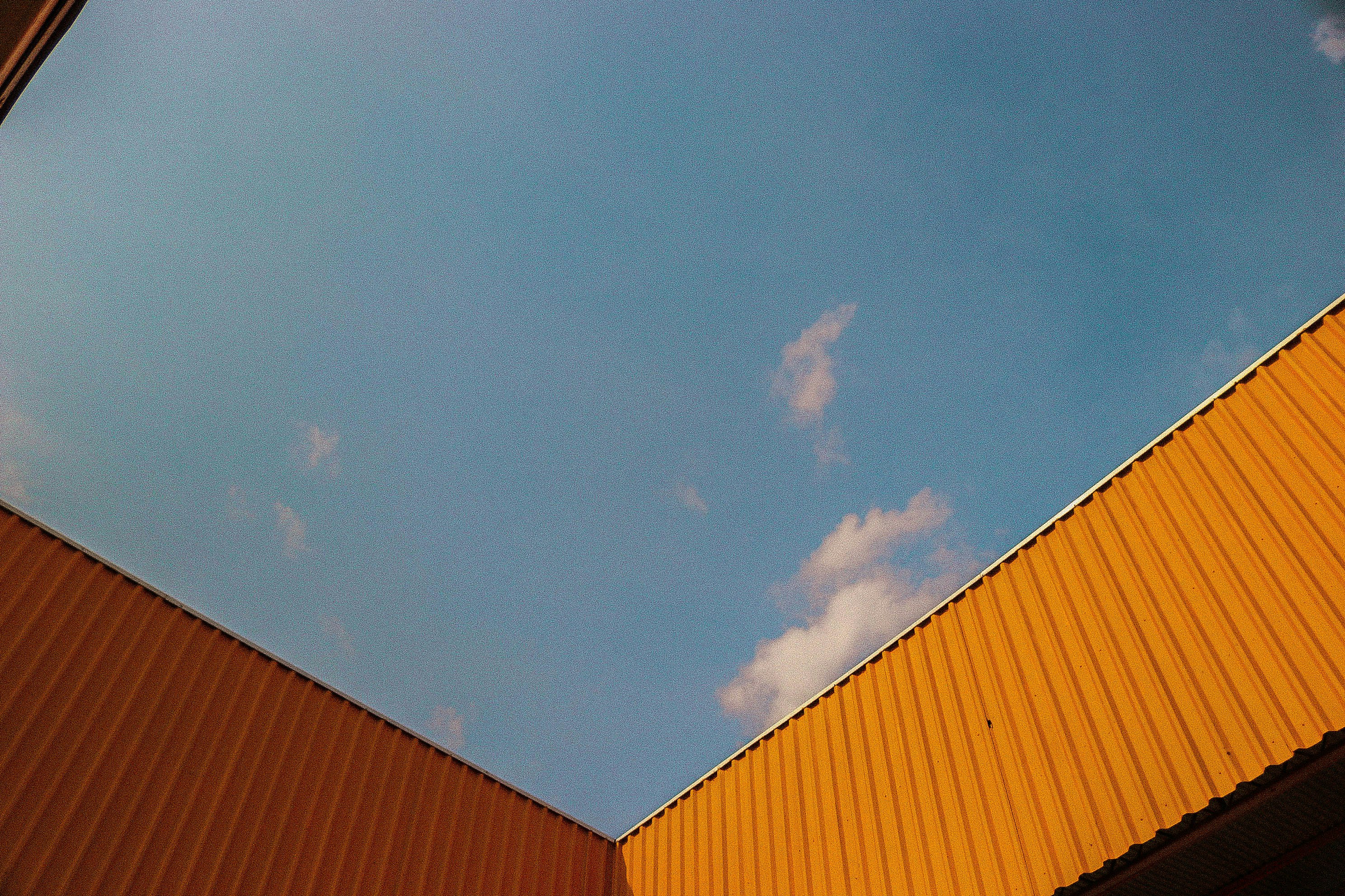 brown and white house under blue sky